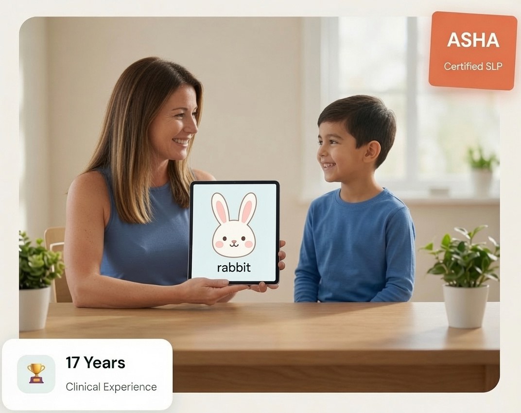 Katie Tashkin, ASHA-certified pediatric speech-language pathologist with 17 years of experience, using a picture flash card during a speech therapy session with a smiling young boy